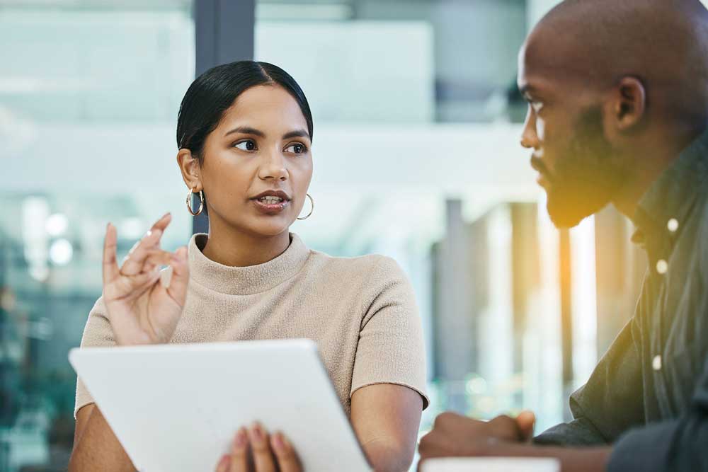 A man and woman engaged in conversation, sharing thoughts and ideas in a friendly setting.