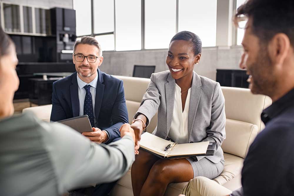 Business people of various backgrounds shaking hands.