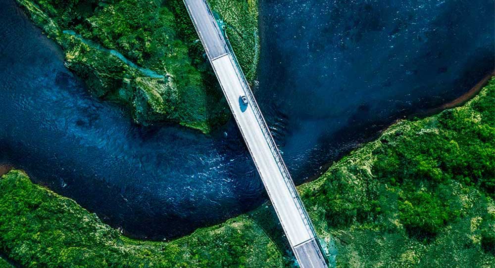 Aerial picture of a bridge integrated with the natural landscape.