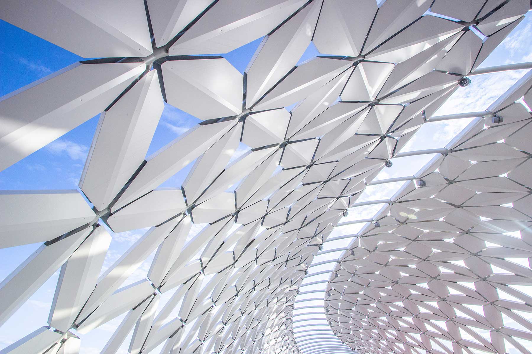 Blue sky with sunlight streaming through a dome opening