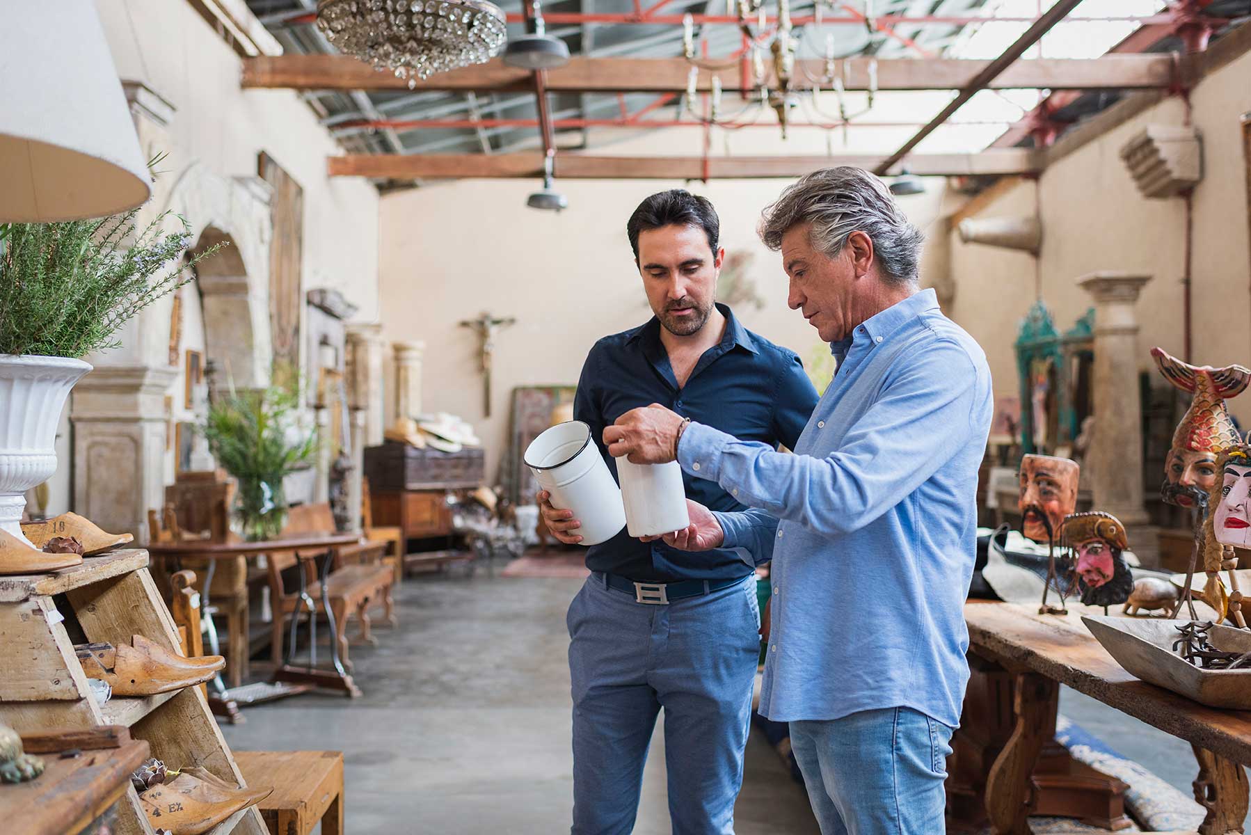 Two men examining various items